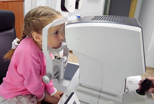 Patient receiving an eye examination with a slit lamp