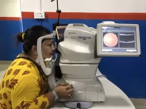 Patient receiving an eye examination with a slit lamp